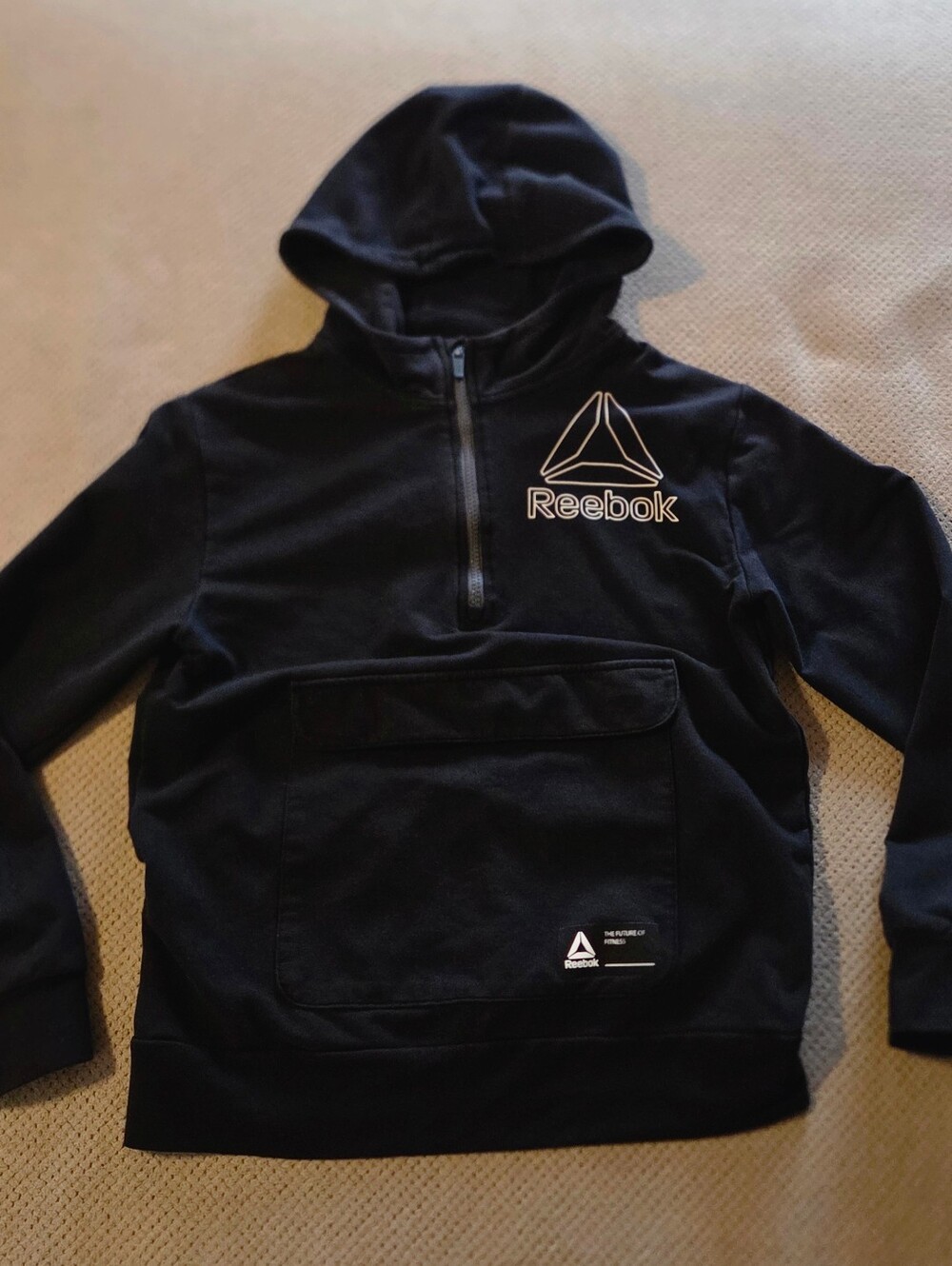 Reebok boys large black quarter-zip hoodie featuring a prominent front flap pock